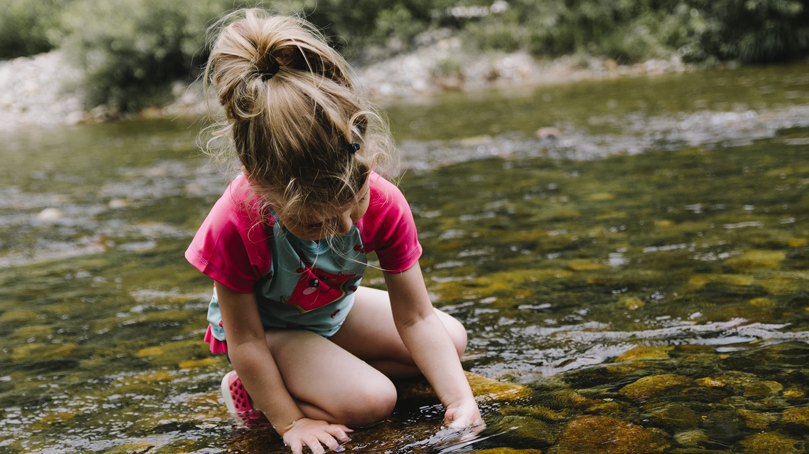 Child playing in the river