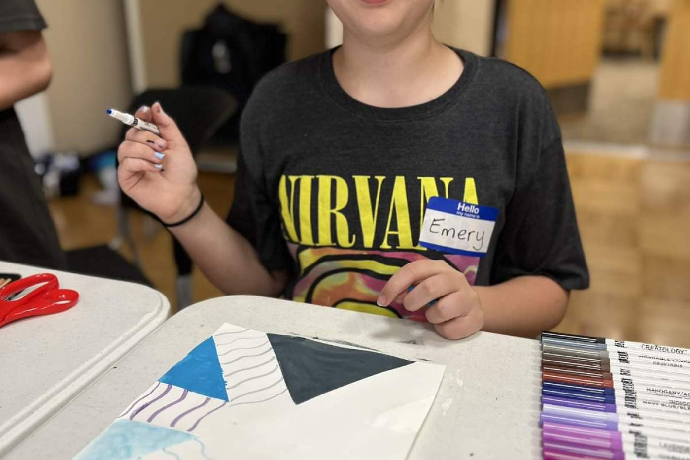 Girl using colored pencils to make art