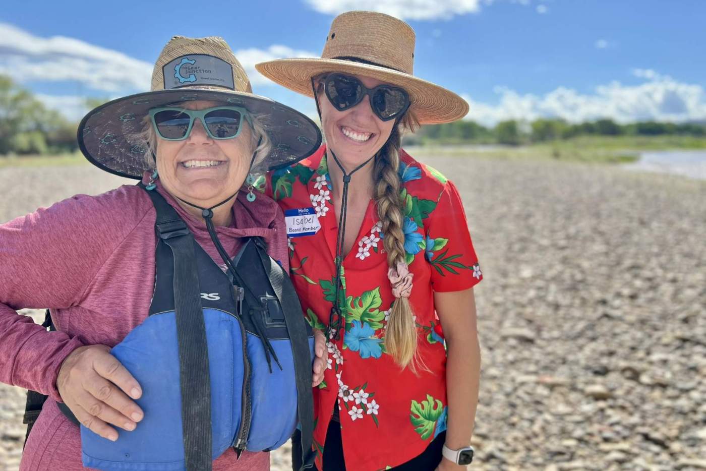 2 women in sun hats by the riverside